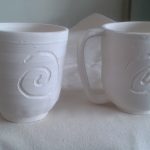 Square handled, carved mugs, unglazed