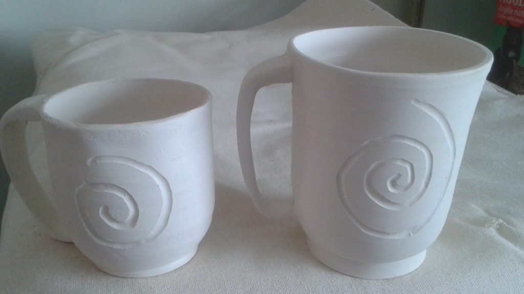 Regular and large carved mugs, unglazed